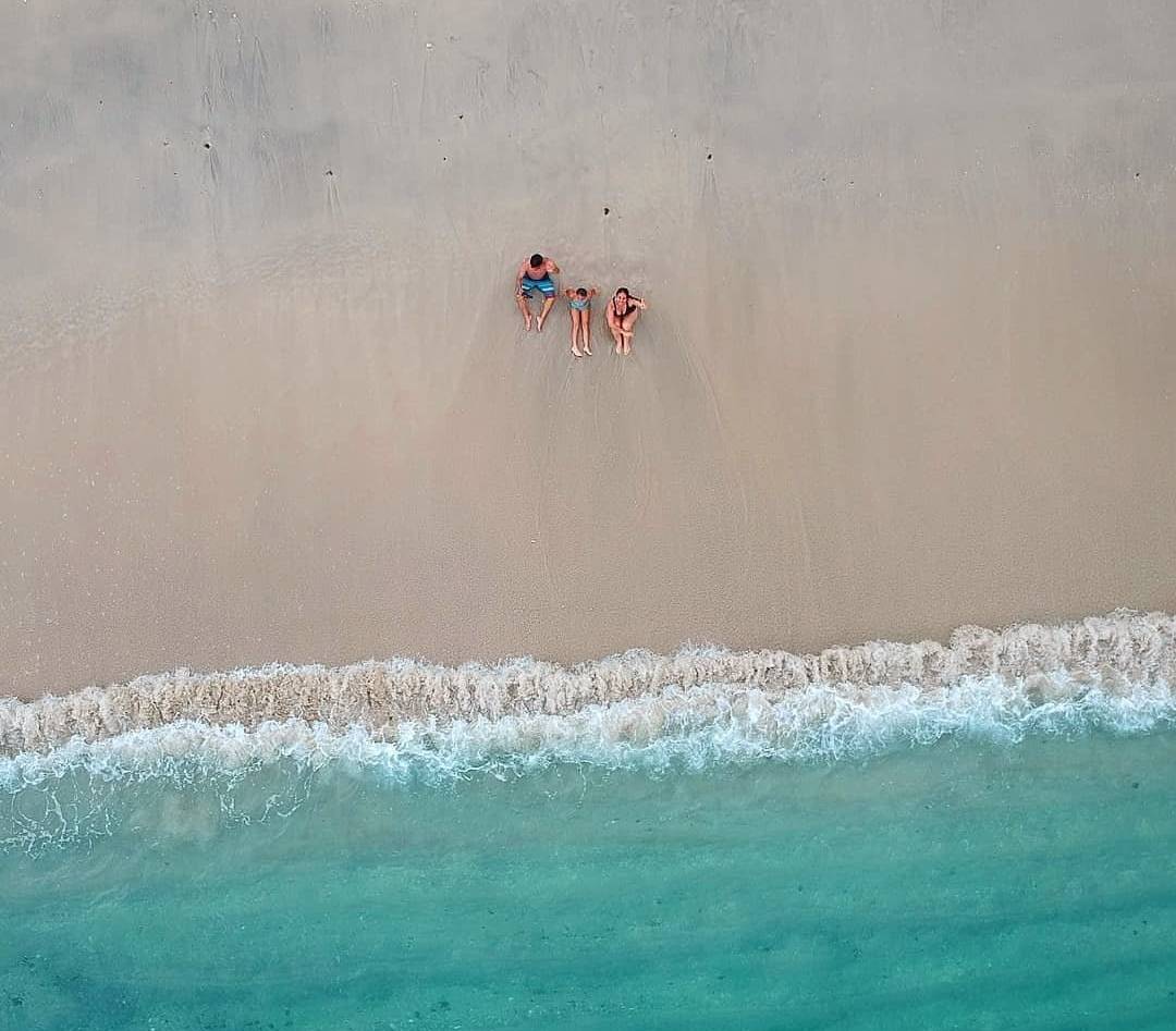 Vista aérea de família sentada na praia